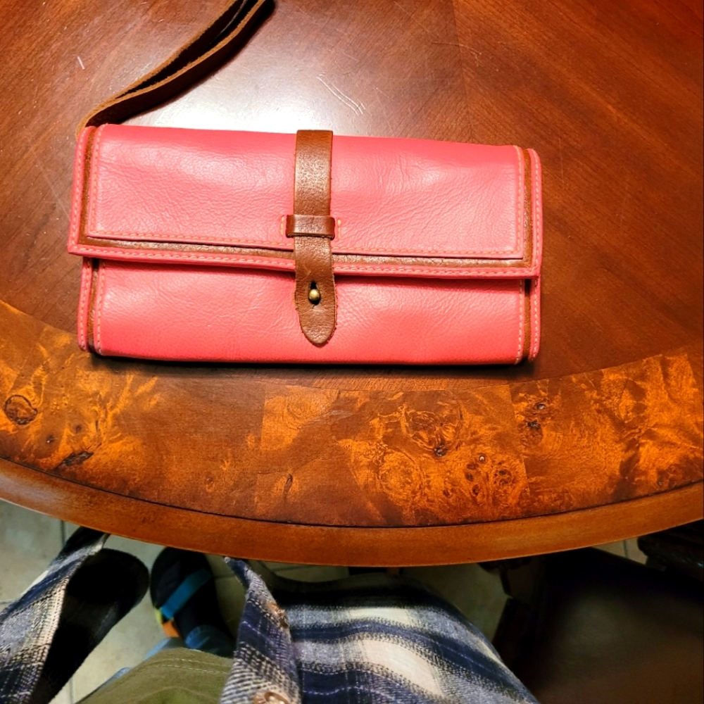 Pink leather handbag with Brown leather Black-and-white inside.
